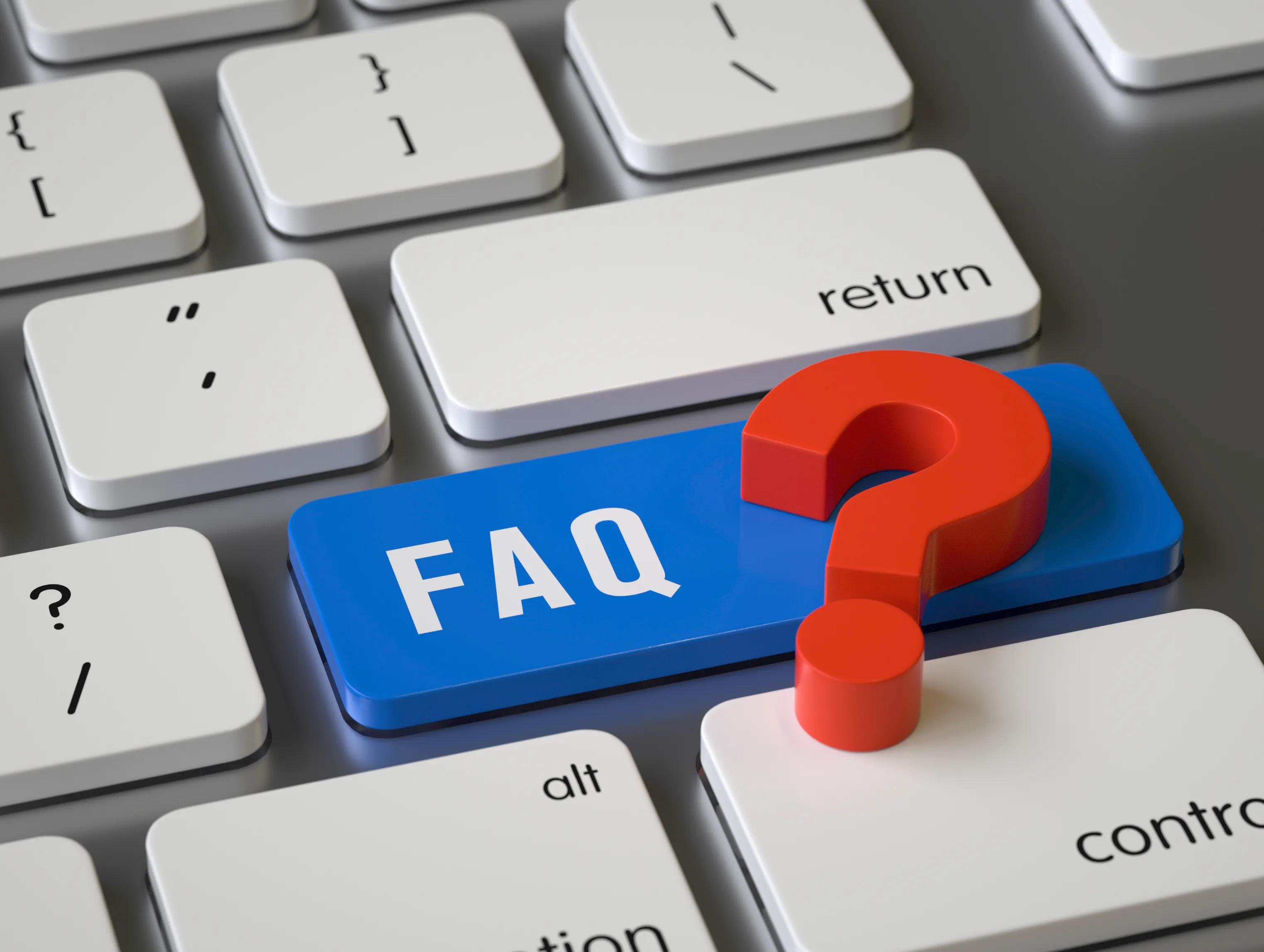 A close-up of a keyboard with a blue FAQ key and a red question mark resting on it.